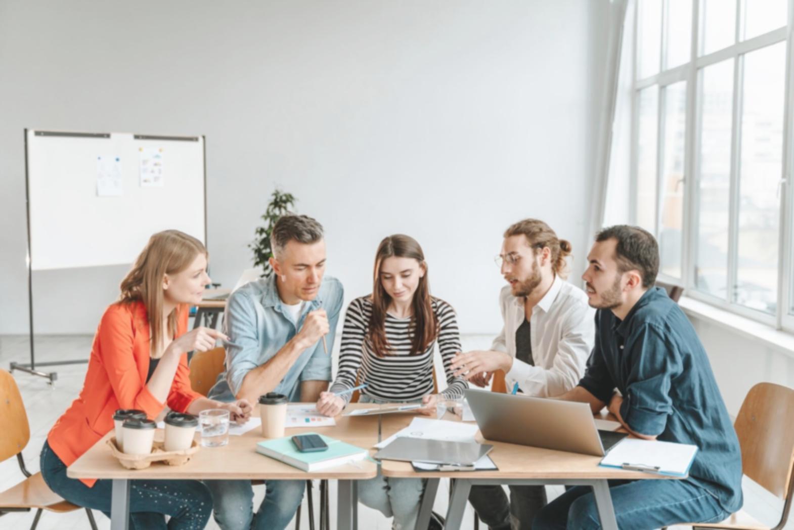 Person reviewing financial documents with calculator and notebook